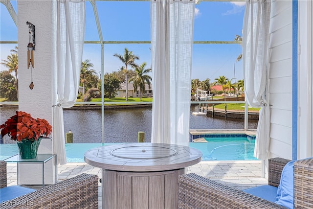 view of swimming pool featuring a water view and a patio area