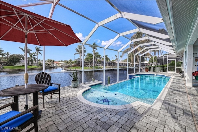 view of pool with a water view, a lanai, and a patio area