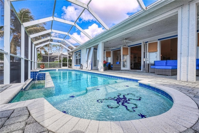 view of pool featuring ceiling fan, outdoor lounge area, a patio area, and glass enclosure