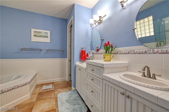 bathroom with tile patterned flooring, vanity, and a tub to relax in