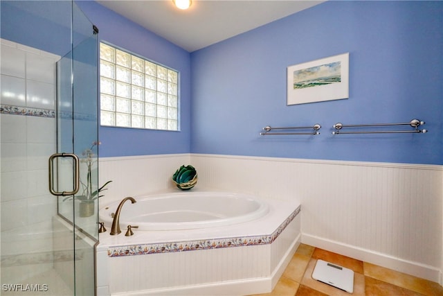 bathroom featuring tile patterned flooring and separate shower and tub