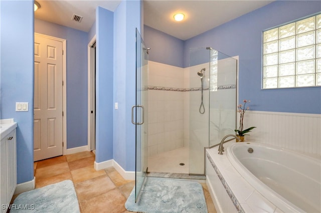 bathroom featuring vanity, tile patterned flooring, and plus walk in shower