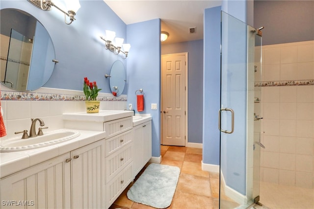 bathroom featuring an enclosed shower, vanity, decorative backsplash, and tile patterned floors