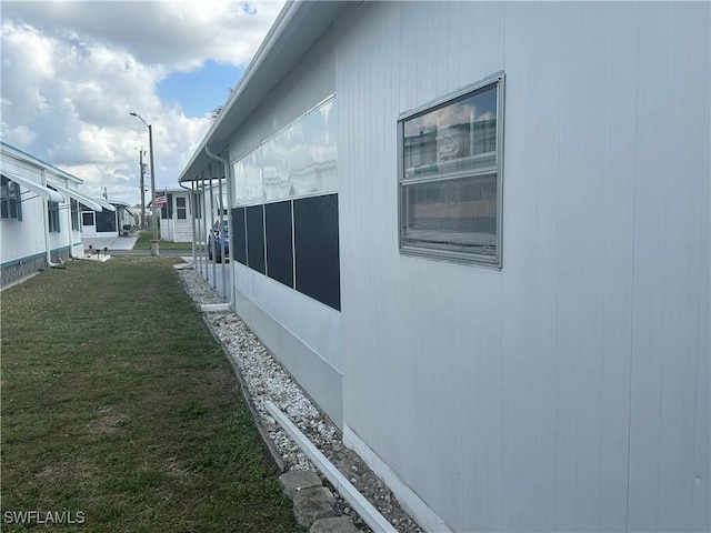 view of side of home featuring a lawn