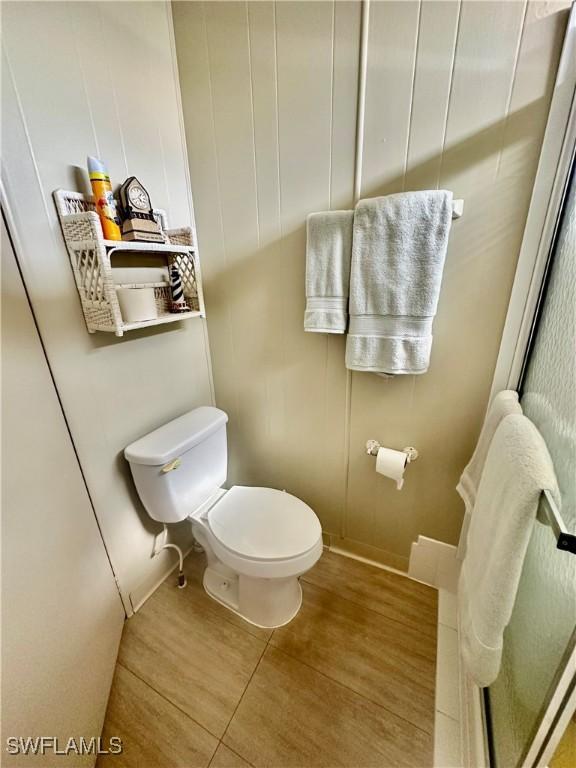 bathroom with toilet and tile patterned floors