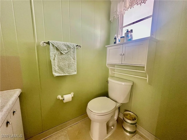 bathroom with toilet and baseboards