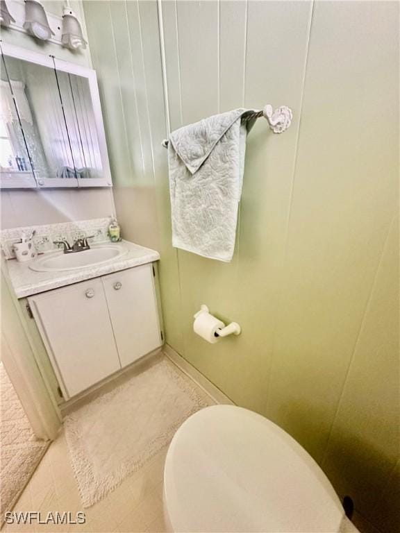 bathroom featuring toilet, vanity, and tile patterned floors