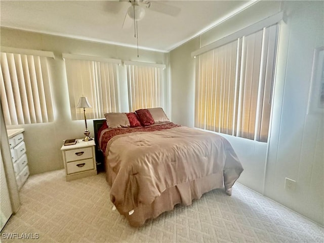 bedroom featuring light carpet and ceiling fan