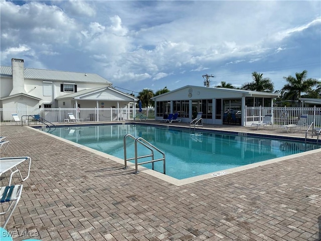 community pool featuring fence and a patio