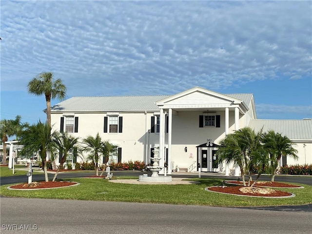 view of front of house with metal roof and stucco siding