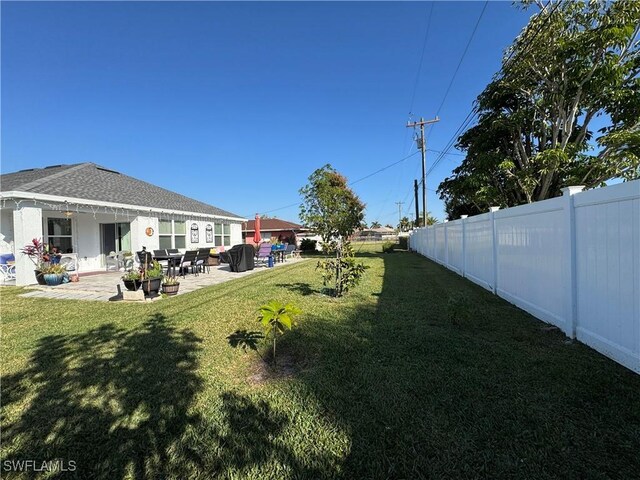 view of yard with a patio area and a fenced backyard