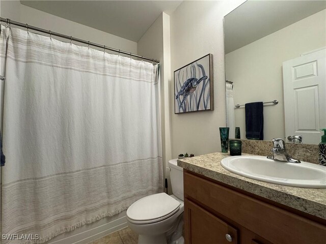 full bath with tile patterned flooring, vanity, and toilet