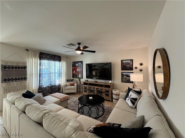 living area featuring ceiling fan