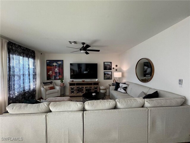 living room with a ceiling fan and visible vents