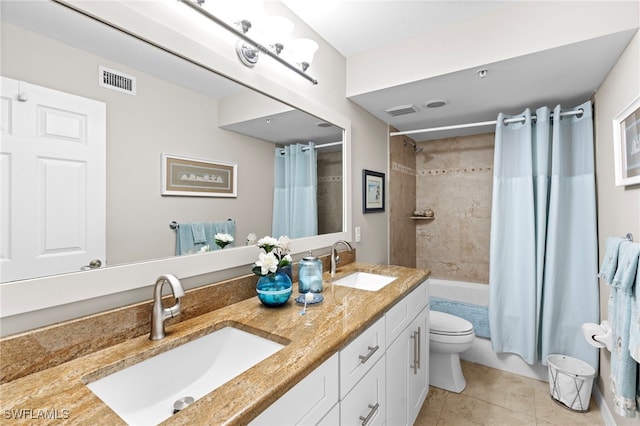 full bathroom with shower / bath combination with curtain, tile patterned flooring, vanity, and toilet