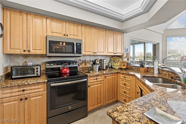 kitchen featuring sink, dark stone counters, electric range, light brown cabinets, and tasteful backsplash