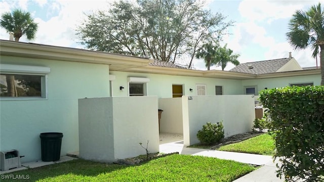 view of side of home with a yard