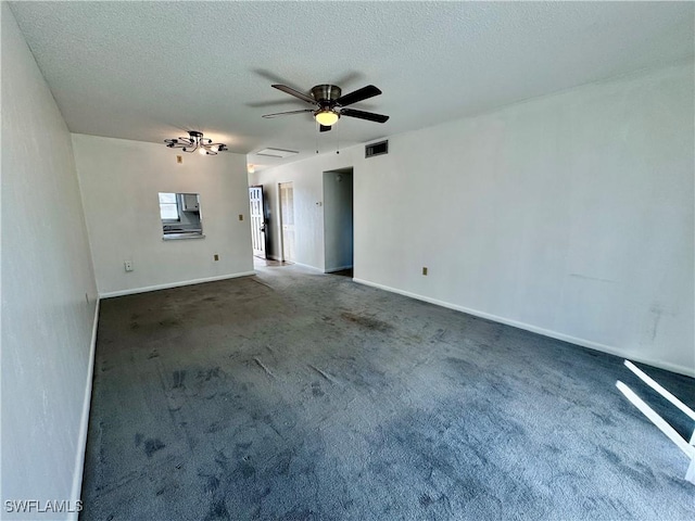 empty room with ceiling fan, a textured ceiling, and dark carpet