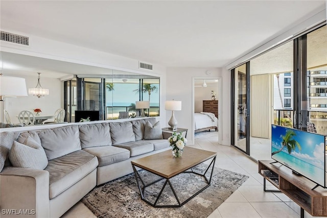 living room featuring light tile patterned floors and an inviting chandelier