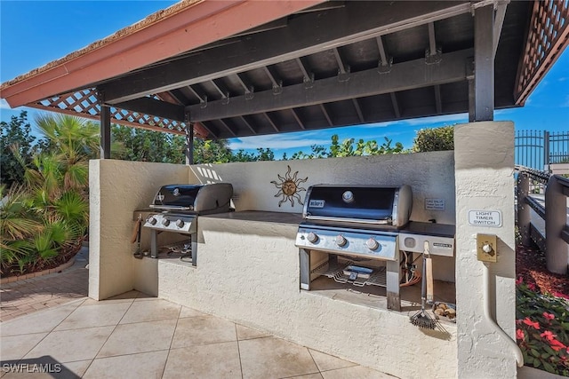 view of patio with area for grilling and a grill