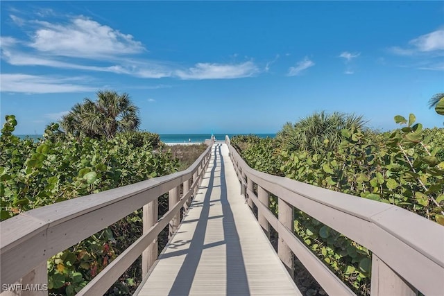 view of community featuring a beach view and a water view