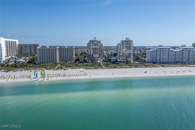 bird's eye view with a water view and a beach view