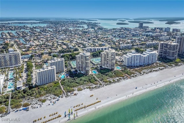 drone / aerial view with a water view and a view of the beach