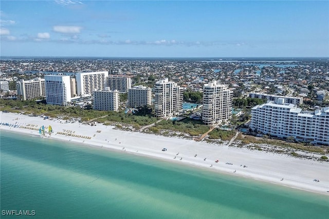 birds eye view of property featuring a beach view and a water view