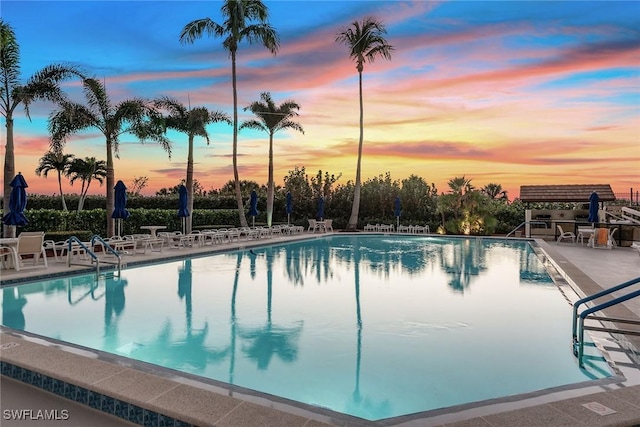 pool at dusk with a patio