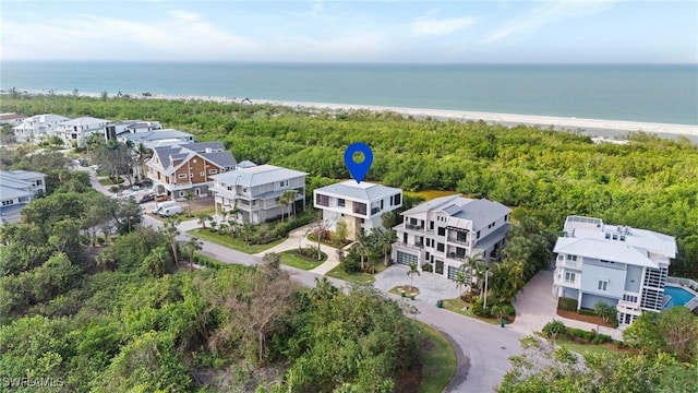 birds eye view of property with a view of the beach and a water view