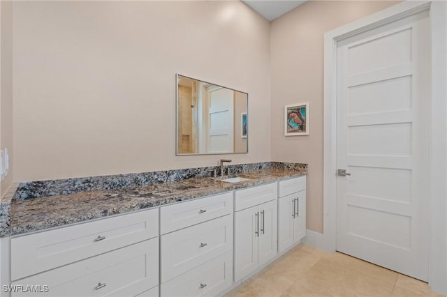 bathroom with tile patterned floors and vanity