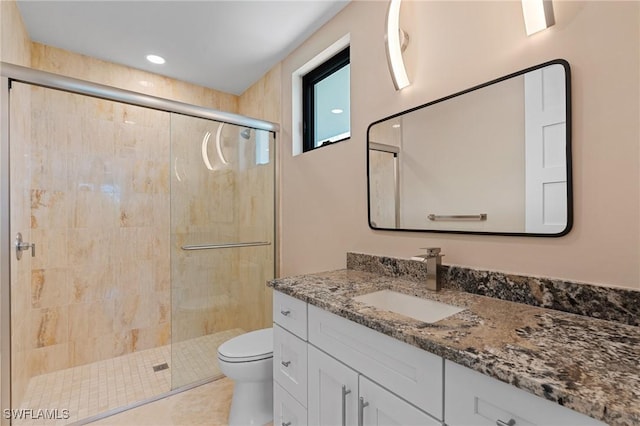 bathroom with vanity, toilet, an enclosed shower, and tile patterned flooring