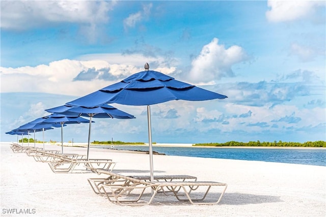 exterior space featuring a beach view and a water view