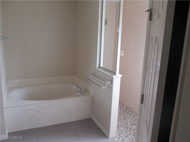 bathroom featuring tile patterned floors and independent shower and bath