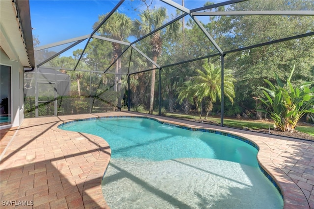 view of swimming pool with pool water feature, a lanai, and a patio area