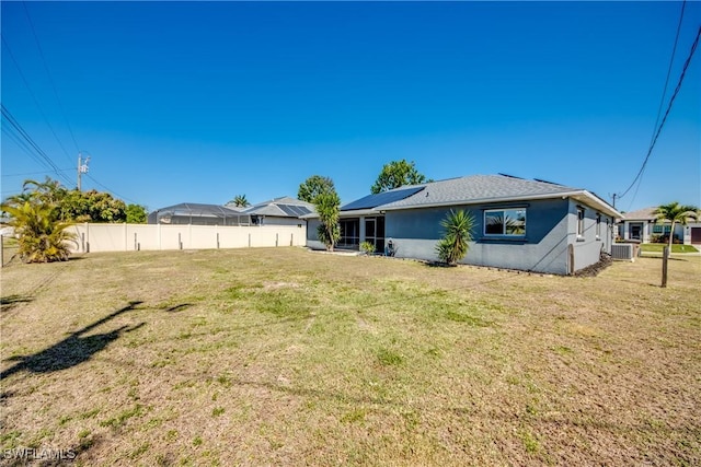 rear view of house featuring a lawn