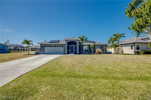 view of front of house featuring a front lawn, glass enclosure, solar panels, and a garage