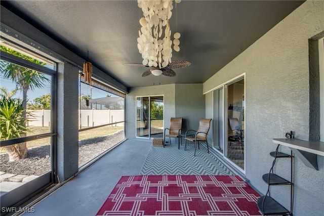 unfurnished sunroom with ceiling fan and a wealth of natural light