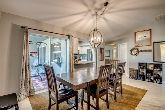 tiled dining area with an inviting chandelier