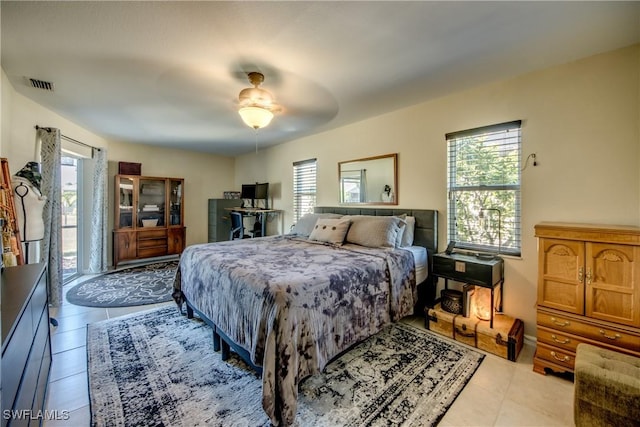 tiled bedroom with ceiling fan