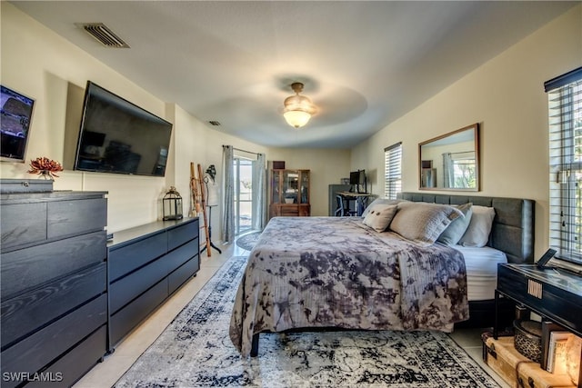 bedroom with light tile patterned flooring, ceiling fan, and access to outside