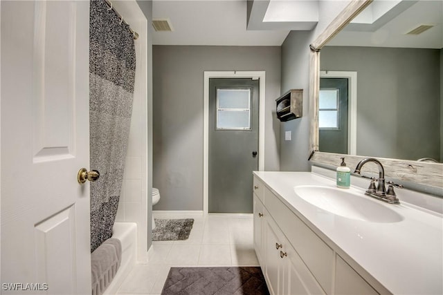 full bathroom with shower / bath combo, vanity, tile patterned flooring, and toilet