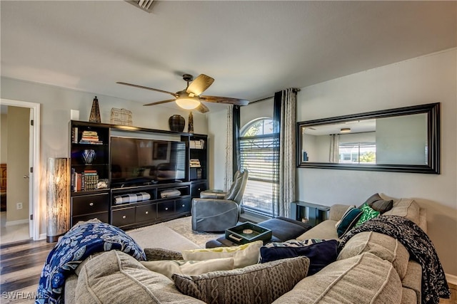 living room featuring hardwood / wood-style floors and ceiling fan