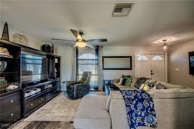 living room featuring ceiling fan and wood-type flooring