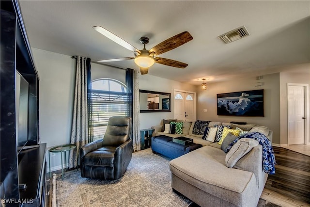 living room featuring hardwood / wood-style floors and ceiling fan