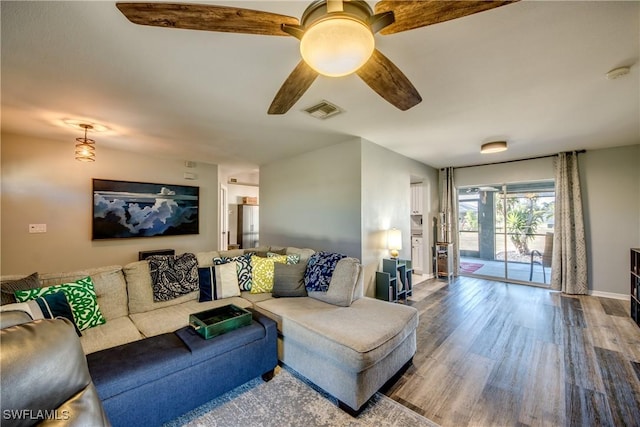 living room with ceiling fan and hardwood / wood-style floors