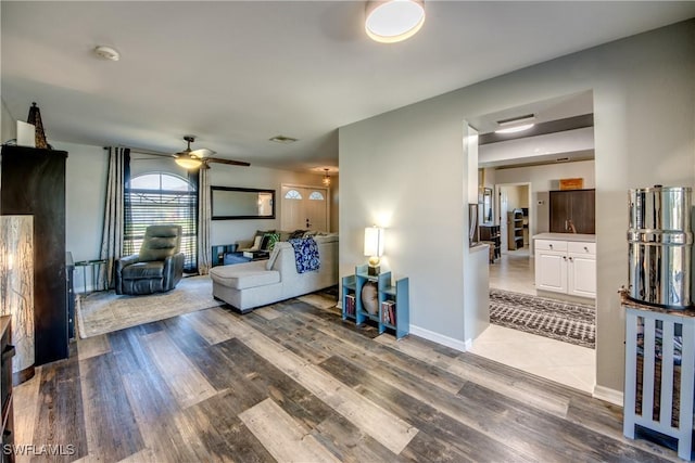 living room featuring hardwood / wood-style flooring and ceiling fan