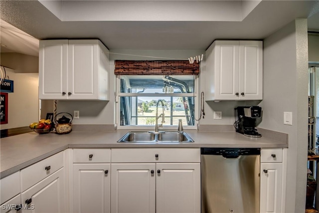 kitchen featuring sink, white cabinets, and dishwasher