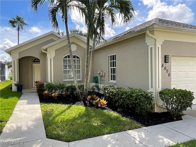 view of front facade with a front lawn and a garage