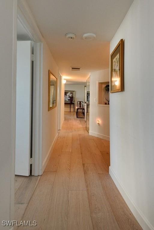 corridor featuring light hardwood / wood-style flooring